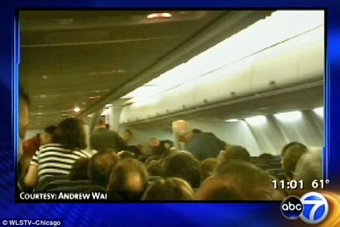 Onboard the American Airlines flight from Chicago where the man yelled God is great while rushing the cockpit as passengers look on in shock.